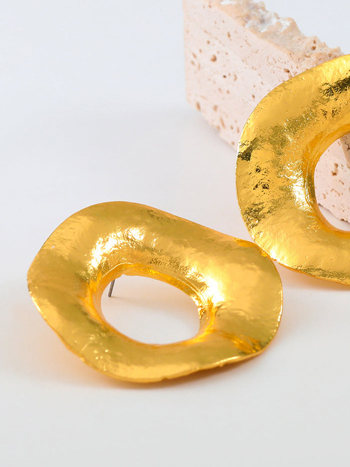 Ronde goudkleurige metalen oorringen met textuur voor een elegante uitstraling