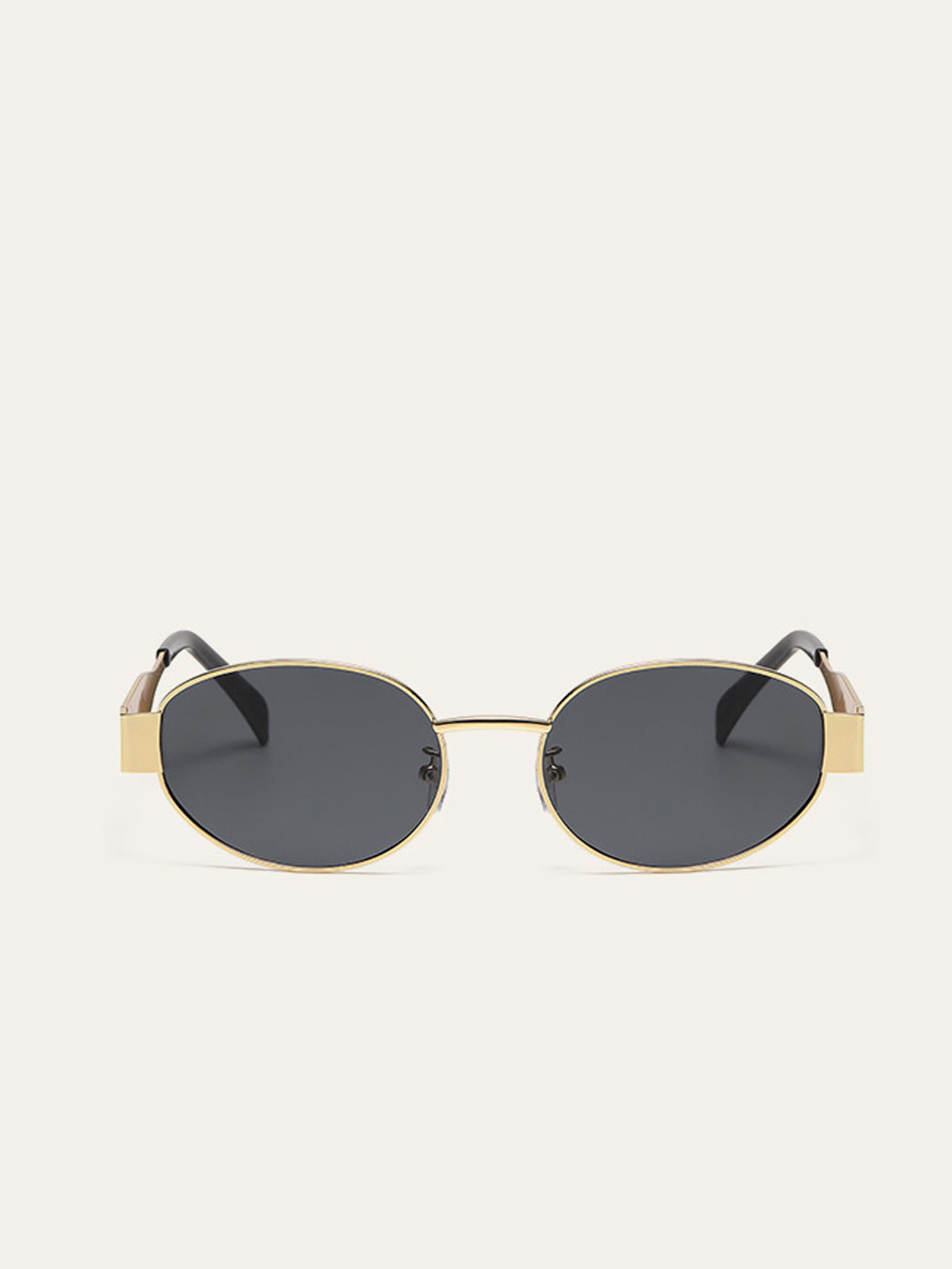 Elegante ovale zonnebril met gouden accenten