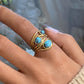 Gouden en zilveren ring met turquoise-inleg voor een elegante en verfijnde uitstraling